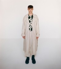 Model wearing the washed nylon trench in soap, with cotton sweater in ivy and nylon trousers in soap.
