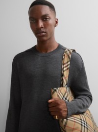 Model wearing grey knitwear, holding Burberry Check Tote Bag