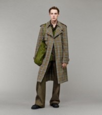 Model wearing Burberry Check Trench Coat paired with Striped Jersey Rugby Shirt and Denim Trousers
