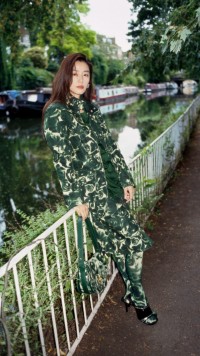 Model wears Rose print waxed cotton field jacket in ivy