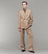 Model wearing Pinstripe Double-Breasted Tailored Jacket and Tailored Trousers in Biscuit and Canopy