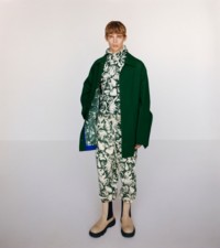 혼방 소재의 카 코트, 아이비 색상의 캐시미어 터틀넥 상의와 조깅 팬츠, 커스터드 색상의 가죽 크리퍼 첼시 부츠를 착용한 모델.