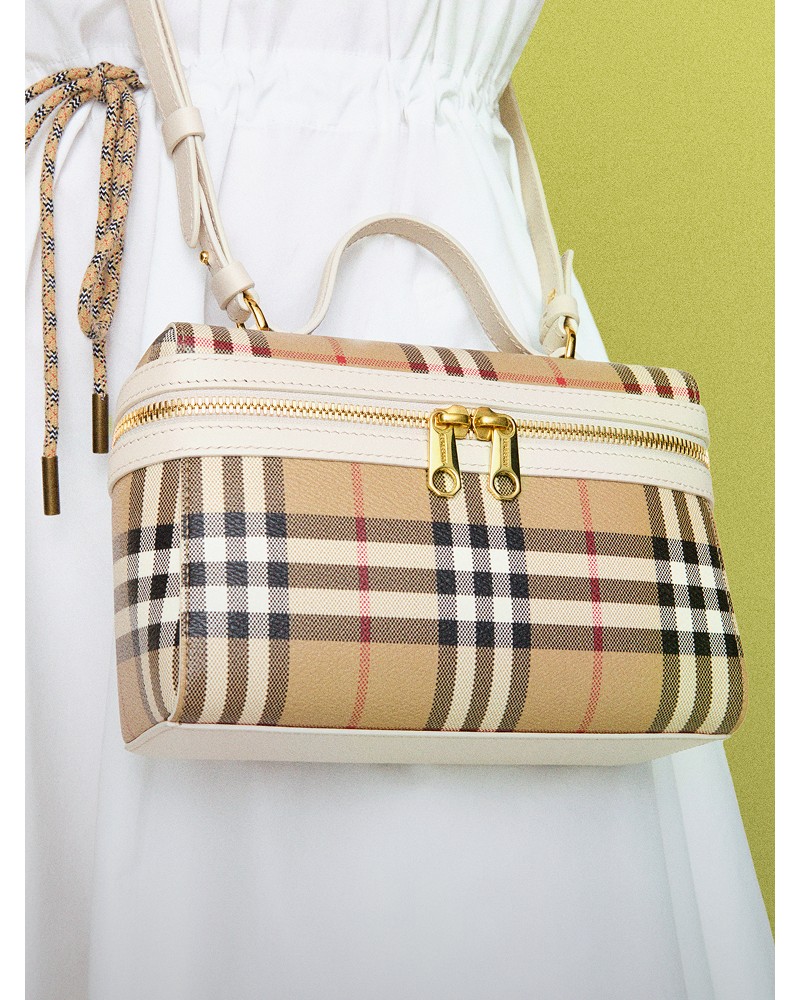 Shot of model wearing the Check Vanity Bag​ in colour Archive beige/soap beige