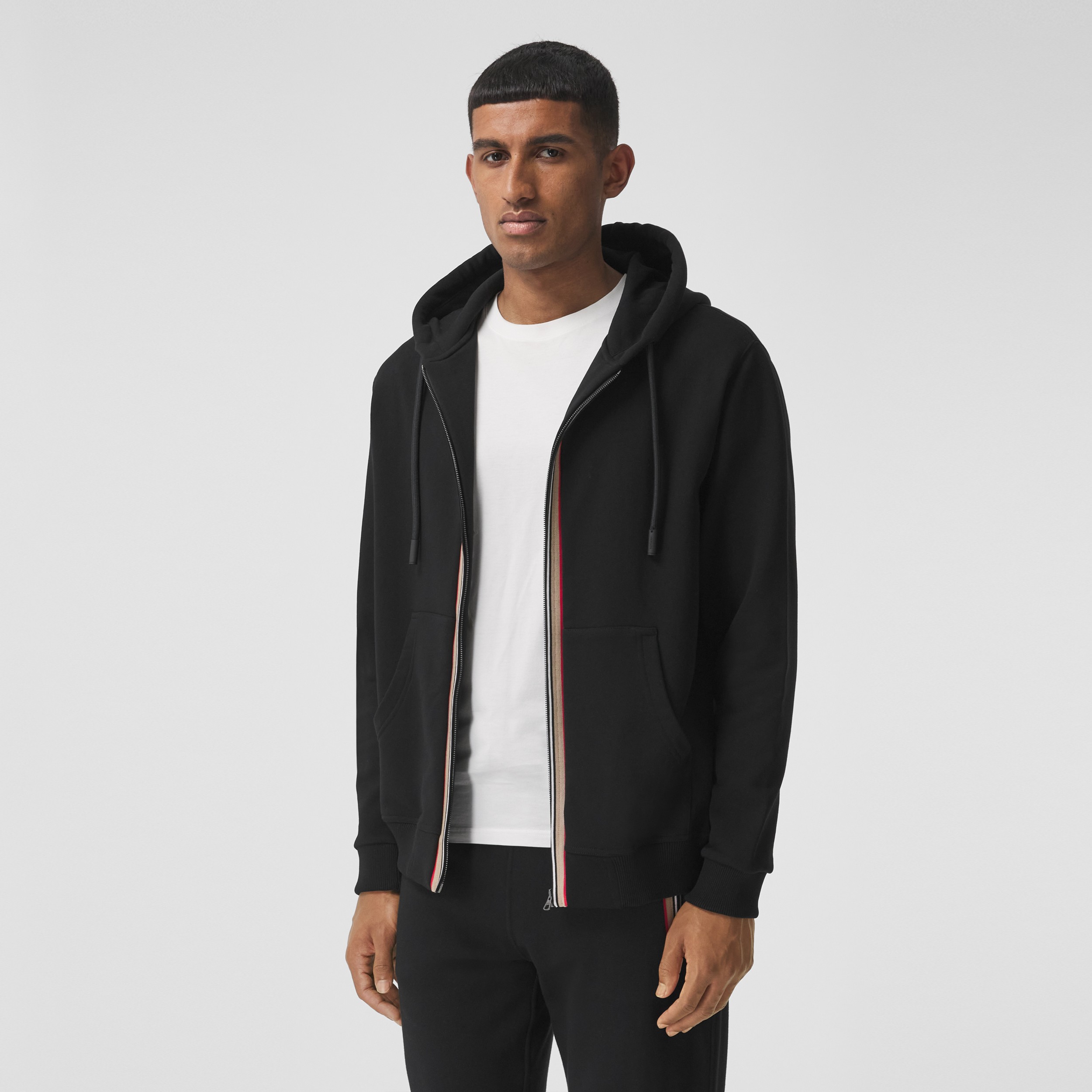 Icon Stripe Detail Cotton Hooded Top in Black - Men | Burberry® Official - 1