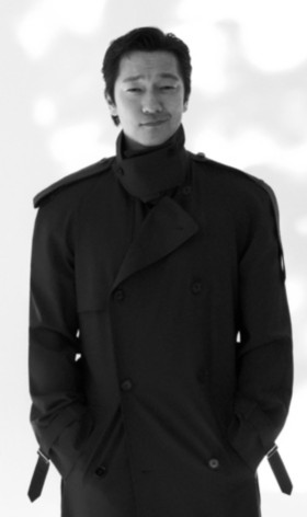 Son Suk-Ku Posing in a Black and White Portrait Image