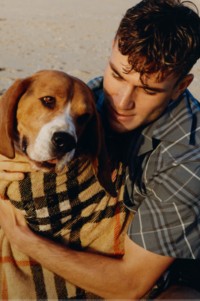 Model wearing Relaxed Fit Check Cotton Shirt in Pewter holding a dog in a Burberry Check towel