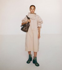 Modal wearing the press-stud collar dress in flax with the EKD small shield tote in military.