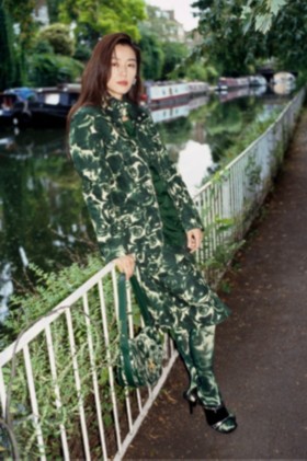 Model wears Rose print waxed cotton field jacket in ivy