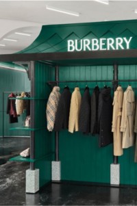 Window display of Burberry products hanging on a clothing rack