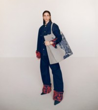 Model wearing Denim jacket and jeans in indigo blue, with EKD tote in knight and Shearling Pointy mules in dark espresso.