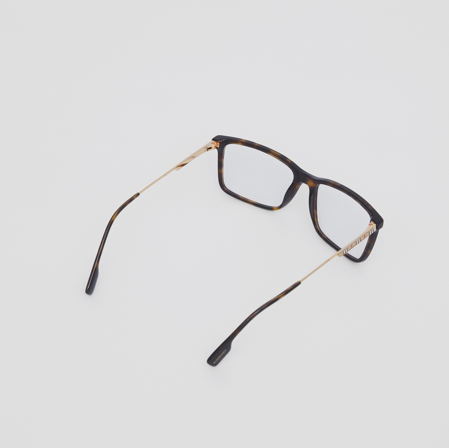 Óculos de grau com armação retangular e detalhe de listras icônicas