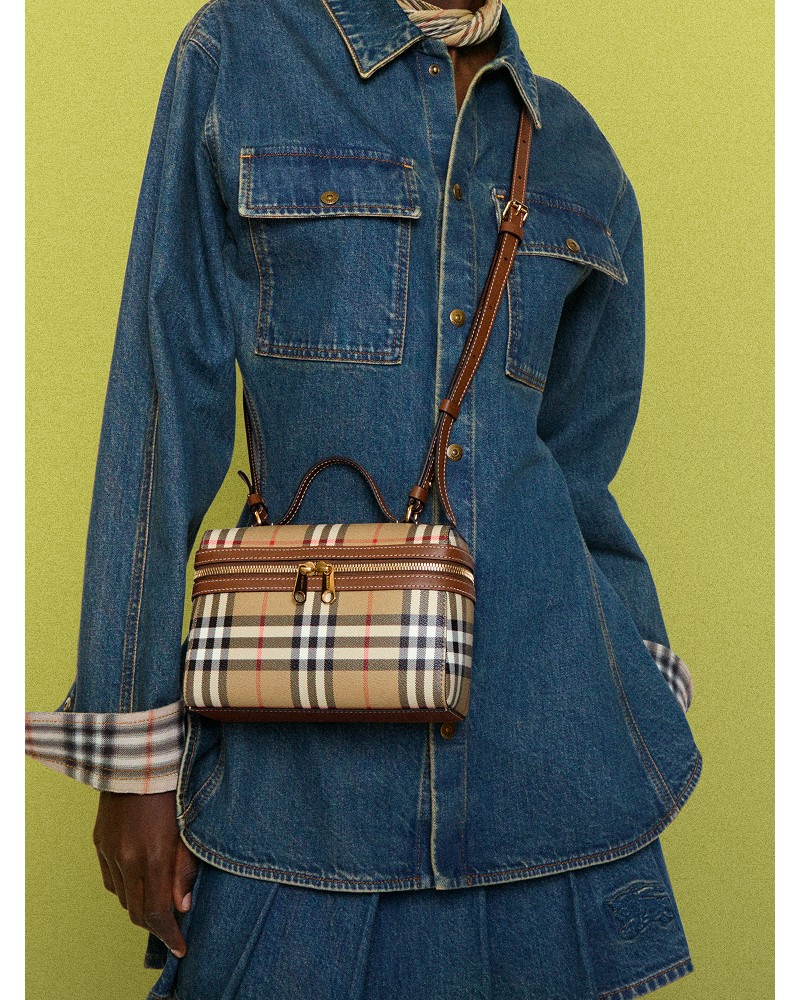Shot of model wearing the Check Vanity Bag​ in colour Archive beige/briar brown