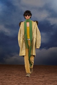 Burberry SS26 Show model Max Everist wearing a Fringed check coated parka and a green Knitted scarf