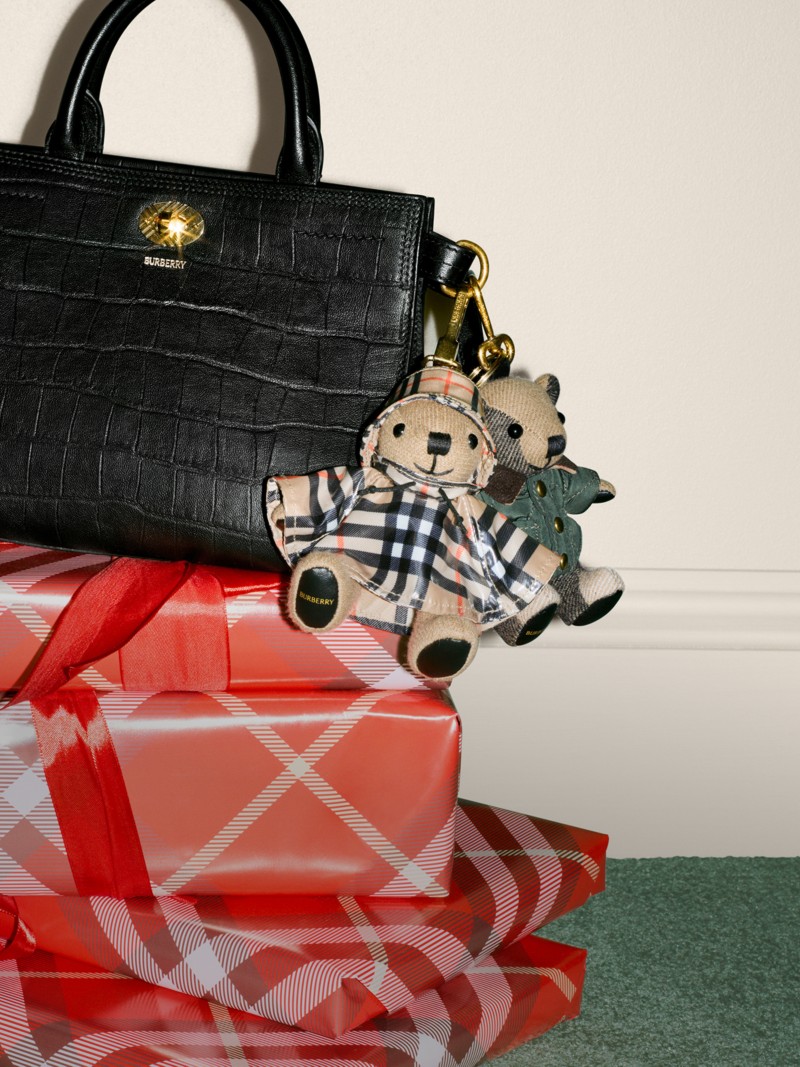 Burberry Festive Campaign featuring the cotswolds bag in black with crocodile-effect leather and two bear chain charms. 