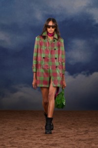 Burberry SS26 Show model Bebe Parnell wearing a pink and green Check coated trench coat and Waxed suede Ledger boots