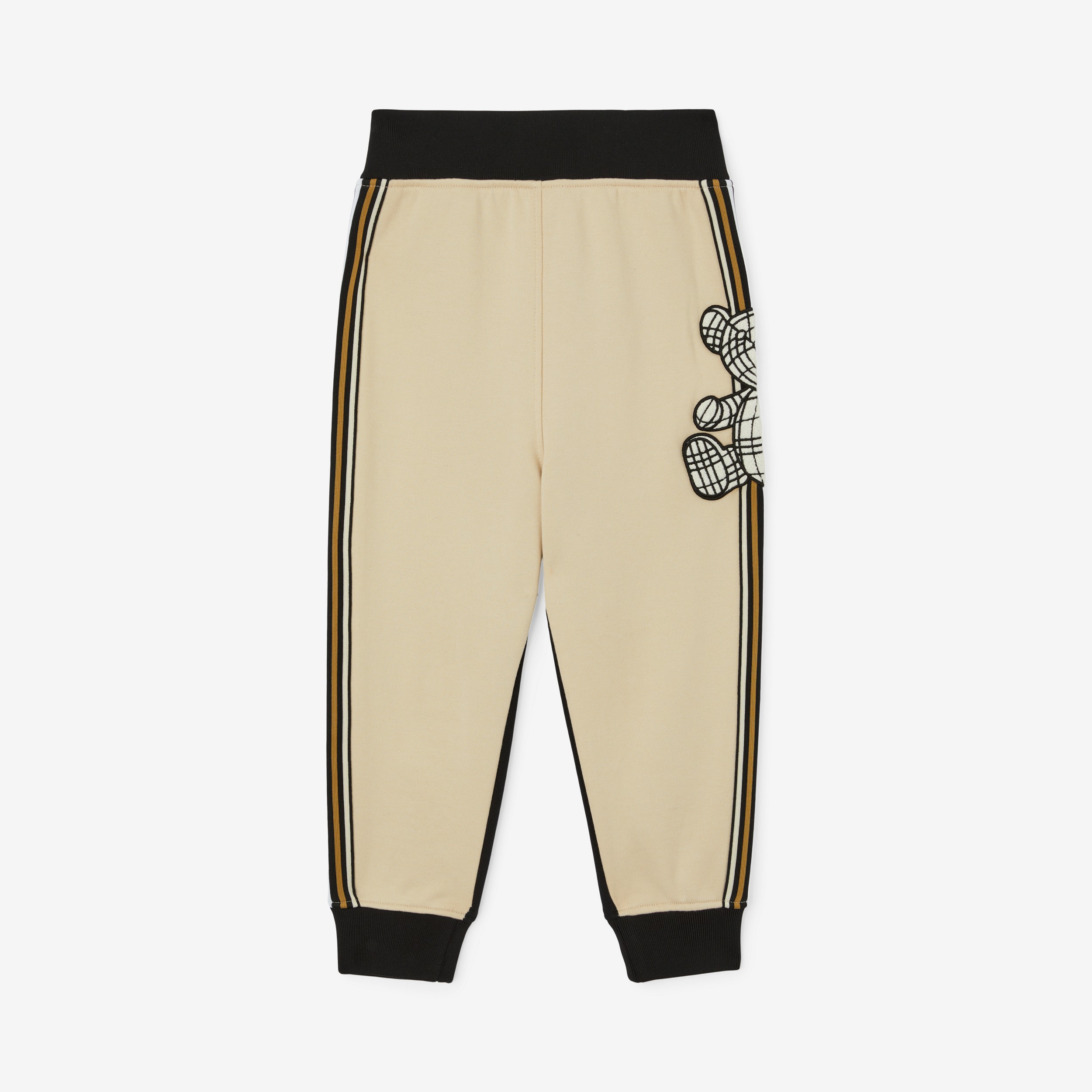 Pantaloni da jogging in cotone bicolore con applicazione orsetto Thomas (Beige Mandorla) | Sito ufficiale Burberry® - 1