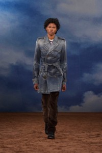 Burberry SS26 Show model Amir Ogumsi wearing a Coated denim trench coat and Corduroy trousers