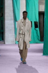 Model wearing zip car coat in grey, with Silk canvas shirt in crater and zip trousers in umber and sand.