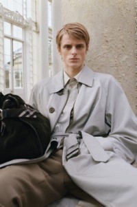 Model wearing Burberry grey trench coat and Burberry B Clip Holdall Bag in Weald