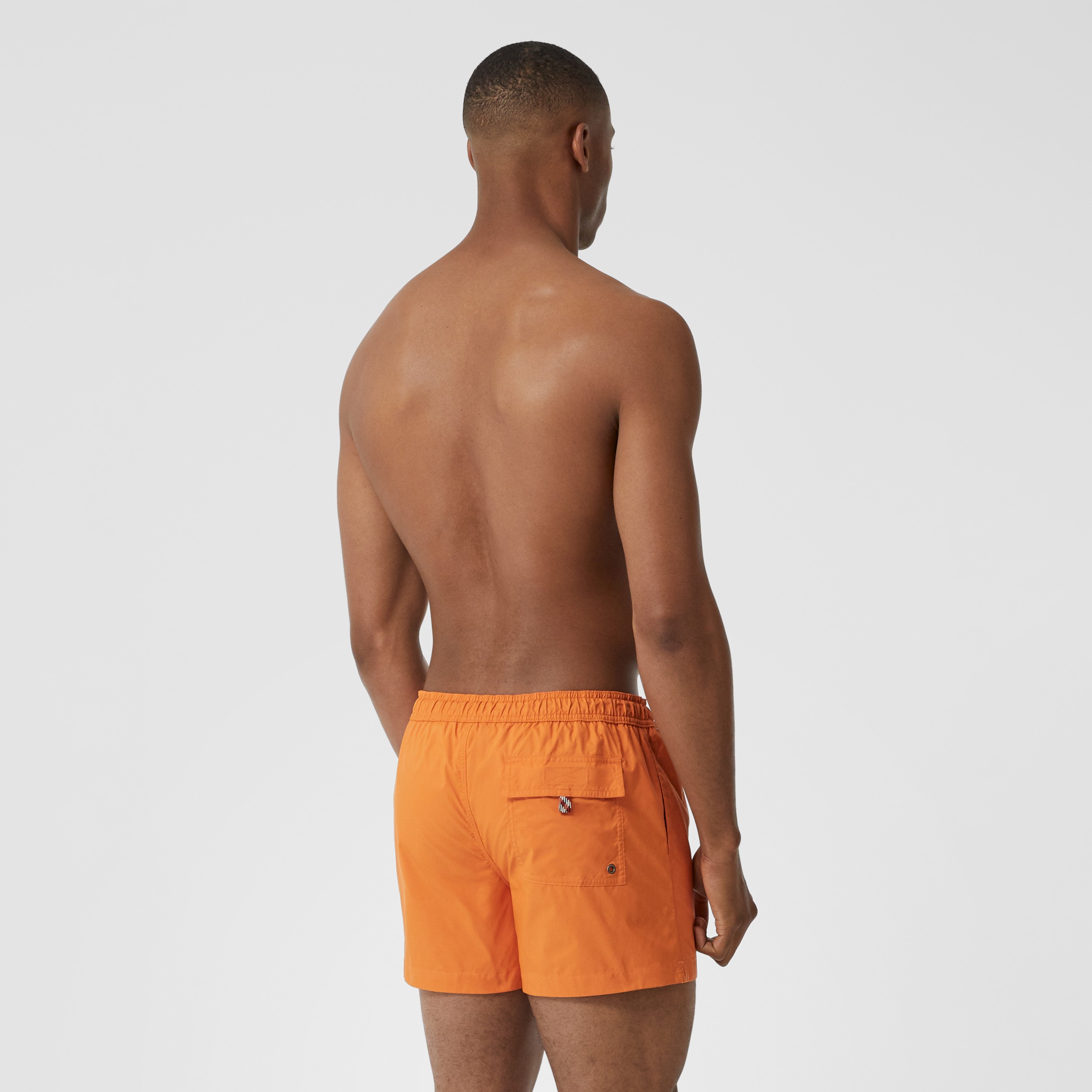 Logo Appliqué Drawcord Swim Shorts in Bright Orange - Men | Burberry