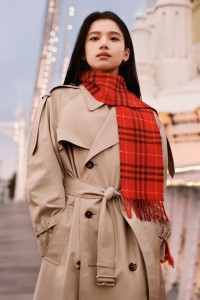 Chinesische Schauspielerin Jingyi Zhang in einem Burberry-Trenchcoat mit einem roten Schal im Burberry Check-Karomuster