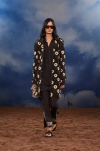 Burberry SS26 Show model Haojie Qi wearing a Macramé knit leather car coat and Embroidered wool silk trousers