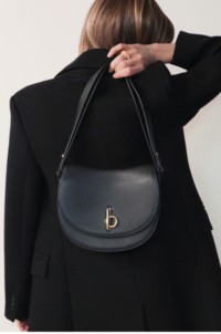 Burberry model holding Mini Rocking Horse Bag in Black