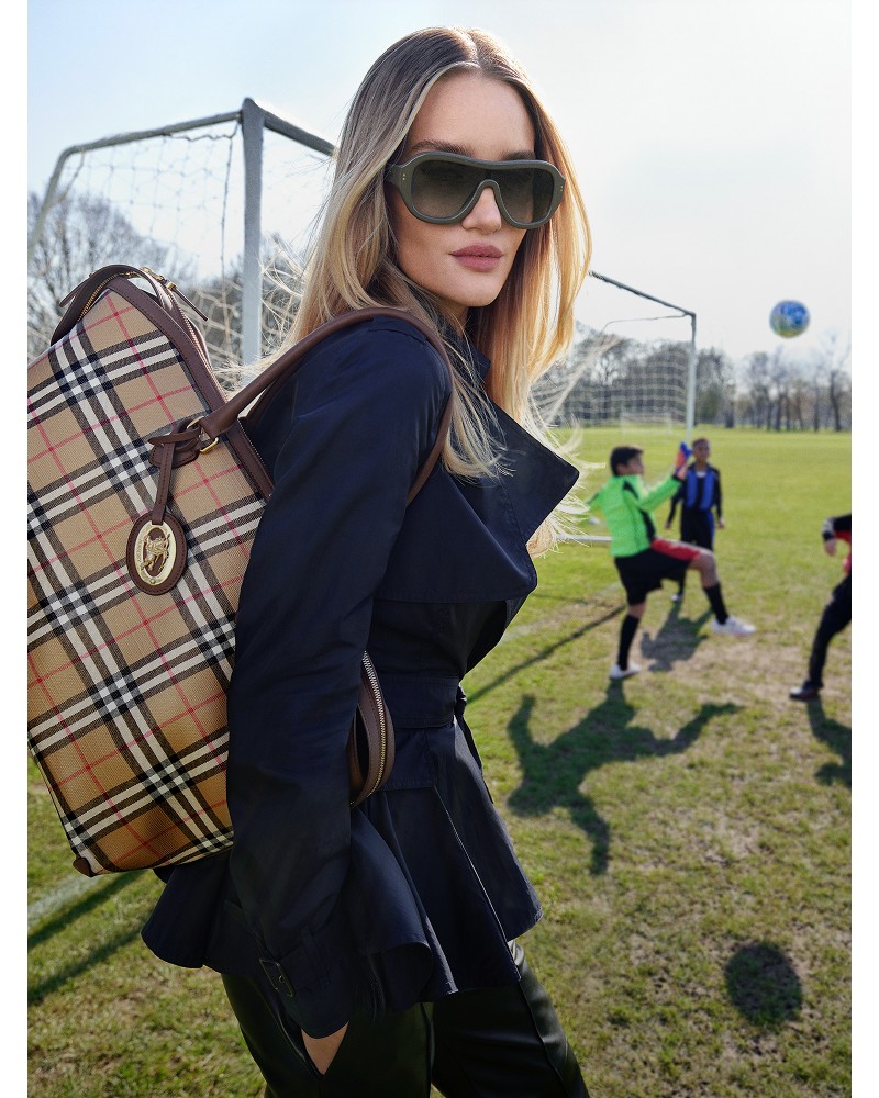 Shot of a model Rosie-Huntington Whiteley in the Burberry Pembury jacket, holding a Burberry Check Tote​ Bag