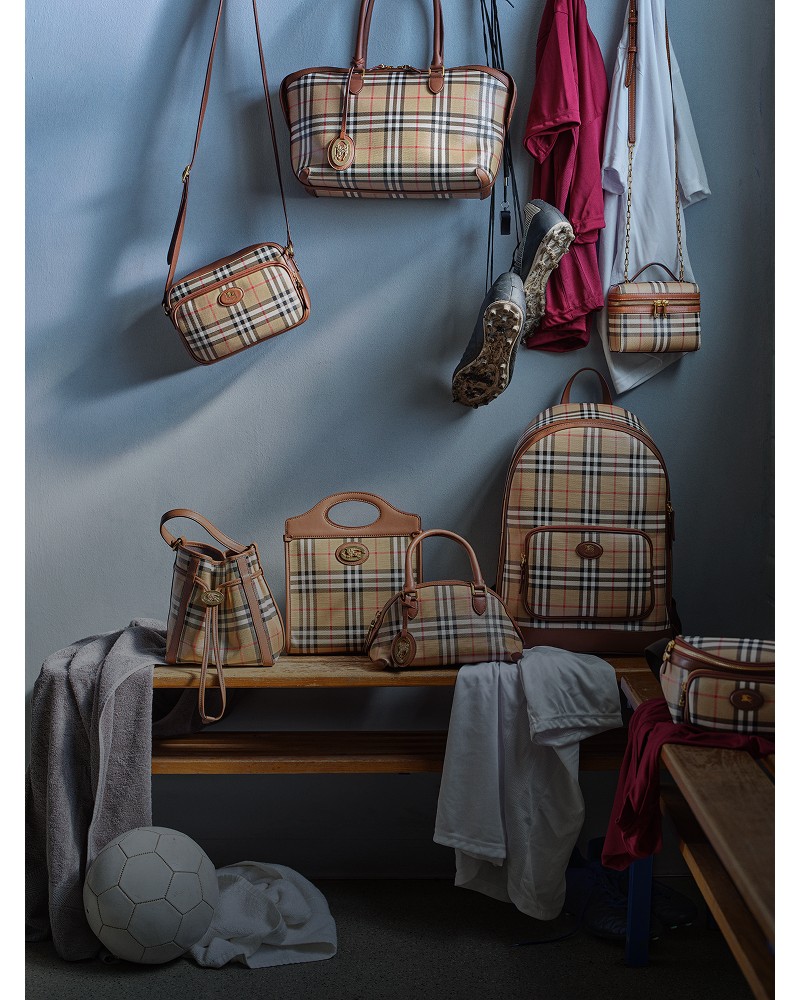 Shot of a locker room, with a variety of Burberry Check Bags hanging off the coat hooks and placed on the benches