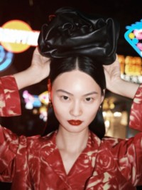 Model wears Rose Clutch bag in Black
