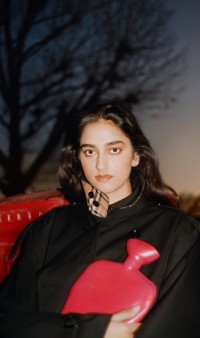 Brand 01 Campaign featuring model wearing a trench coat, holding a red water bottle