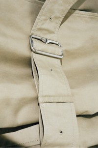 Close up shot of Burberry Heritage Trench Coat, with Silver Buckle detailing. 