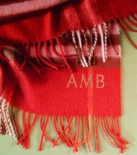 Shot of Burberry Check Scarf with embroidered initials AMB in the corner of the product