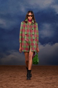 Burberry SS26 Show model Bebe Parnell wearing a pink and green Check coated trench coat and Waxed suede Ledger boots
