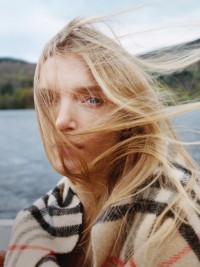 Model wearing Burberry Check Scarf in colour Sand