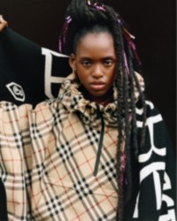 Model wearing Burberry Check Lightweight Jacket in colour Sand