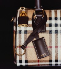 Shot of Burberry Check Scarf with embroidered initials AMB in the corner of the product