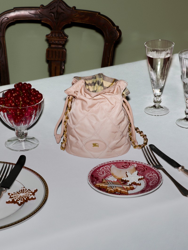 Burberry Festive Campaign featuring the horseshoe chain pouch in pink. 