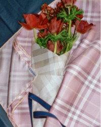 Mother's Day Gifting Campaign featuring red flowers wrapped in Burberry check silk scarves