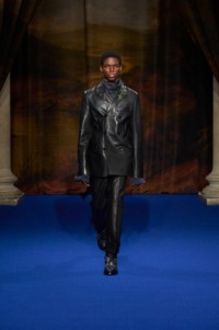 Alex Kosi wearing leather tailored jacket & trousers in black, with silk jacquard shirt in silhouette black and Burberry Check intarsia leather boots in storm blue.