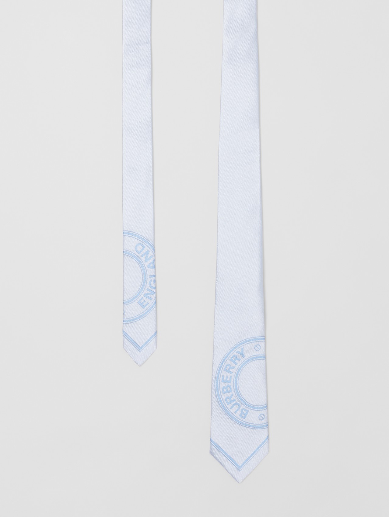Corbata de pala moderna en seda con logotipo gráfico en jacquard (Azul Pálido)