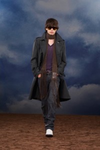 Burberry SS26 Show model Solway Howie wearing a Printed nylon trench coat and a V-neck knit sweater