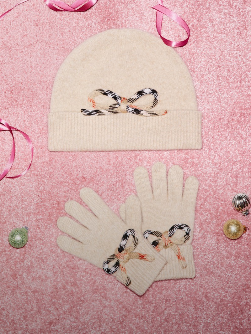 Burberry Festive Campaign featuring Burberry Childrenswear light beige headwear and gloves with check bow detail.