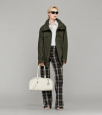 Model wearing Jacket with Striped Shirt, Burberry Check Trousers holding Leather Shield Twin Bowling Bag