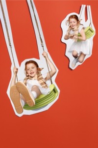 Two Children on swings wearing Children's New Arrivals Collection