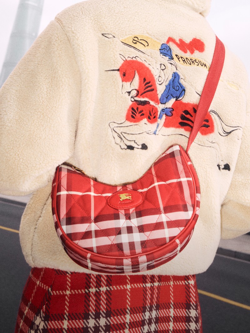 Shot of the back of a Model wearing the Burberry Lunar New Year Collection, with the Horseshoe Crossbody Bag​ in colour Crayon Red