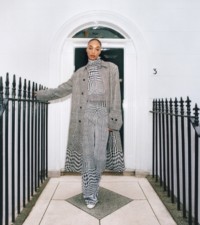 Jourdan Dunn wears Prince of Wales check silk cotton blend jacquard car coat in black and white and Prince of Wales check wool blend jacquard turtleneck top and track pants in black and white