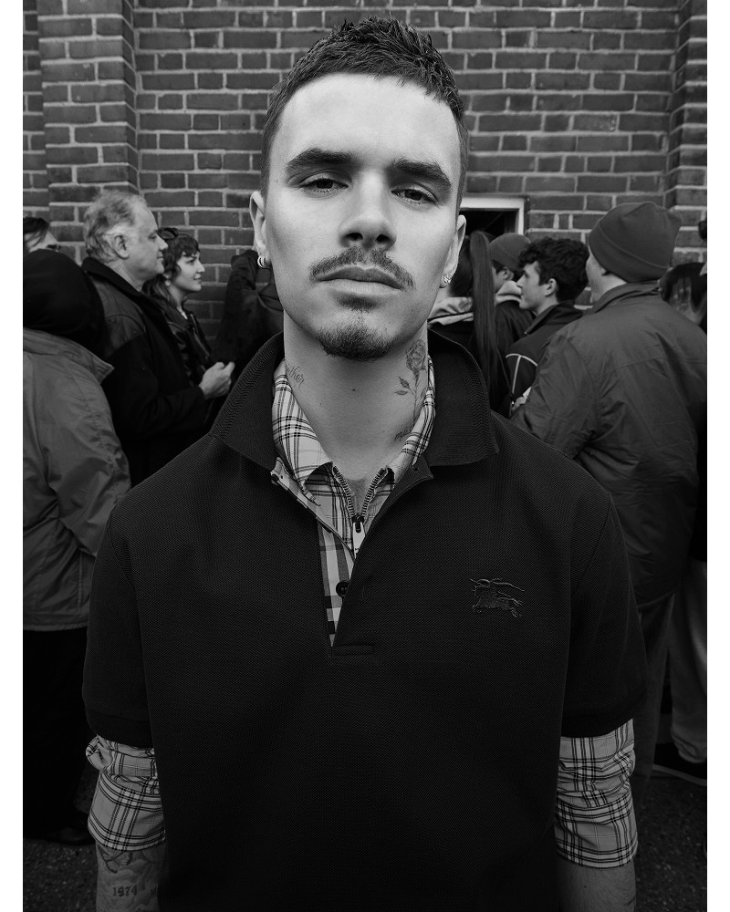 Shot of Romeo Beckham, wearing the Burberry Cotton Polo Shirt in colour Coal blue