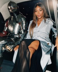 Naomi Campbell sitting in Taxi with Burberry Knight