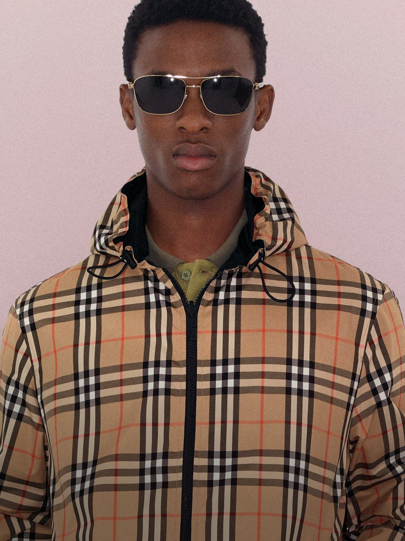 Shot of model wearing Reversible Check Newport Hooded Jacket on pink background.